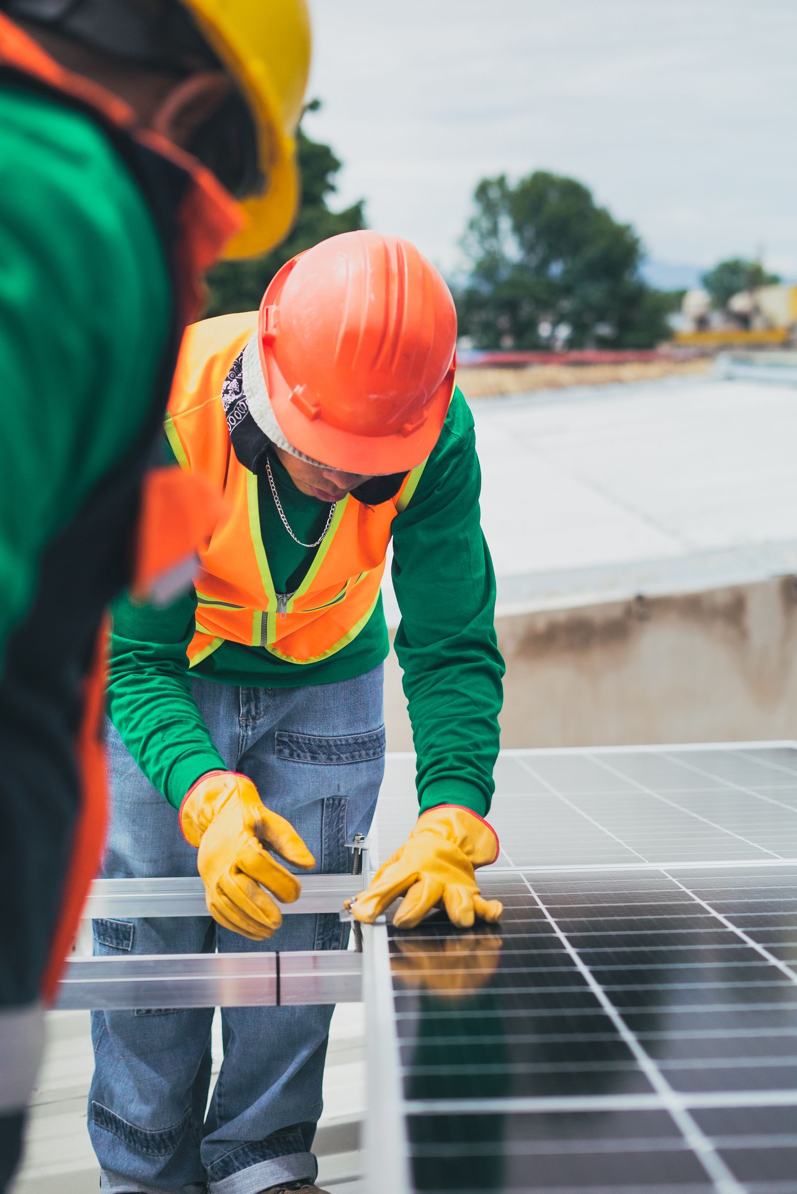 Trabajador con equipo de seguridad instalando paneles en techo